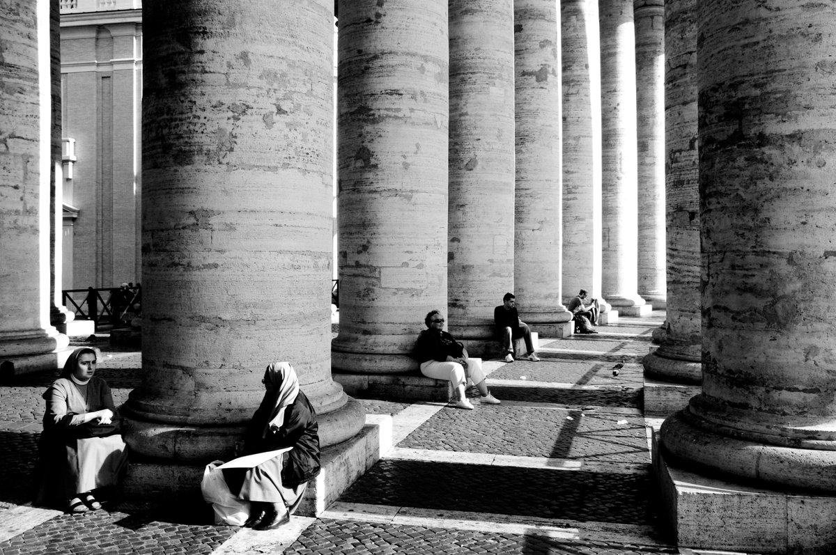 Black and white detail of light and shadow across monumental stone columns